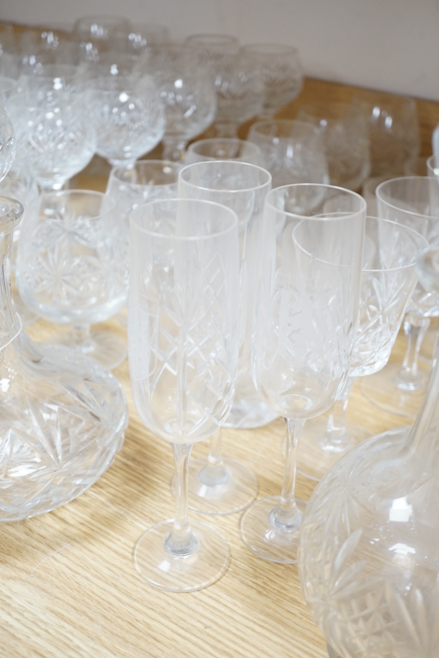 Various suites of star cut Thomas Webb drinking glasses, together with three decanters, pair of whisky tumblers and jug, five tumblers and three engraved Aston Villa champagne flutes, (approx. 89 items)